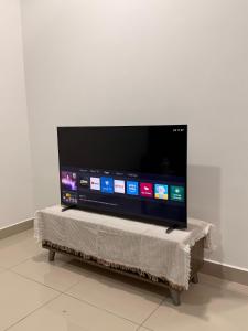 a flat screen tv sitting on top of a table at Goldenstay Mutiara Ville Cyberjaya in Cyberjaya