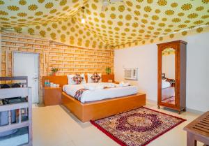 a bedroom with a bed and a mirror in it at Royal Jaisalmer Resort with Swimming Pool in Jaisalmer +30 photos