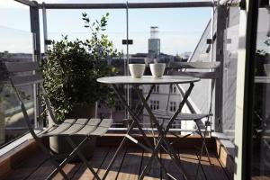 a small table and two chairs on a balcony at Boutique Hotel Hans in Copenhagen +41 photos