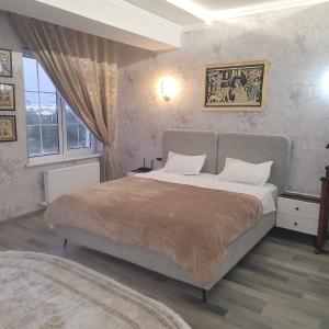 a bedroom with a large bed and a window at Guesthouse in Fergana