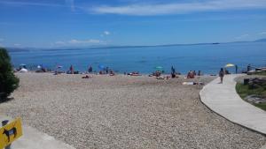 a group of people on a beach with the water at Apartment Rino in Rijeka