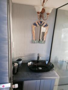 a bathroom with a black sink and a mirror at Nice apartment in Kværs - kitchen and EV charging in Gråsten +11 photos
