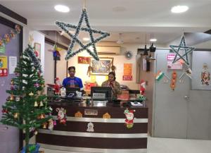 two people sitting at a counter with a christmas tree at The Platinum in Kolkata
