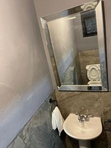 ein Badezimmer mit Waschbecken, Spiegel und Toilette in der Unterkunft Home Nino in Guadalajara