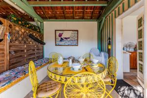 a dining room with a yellow table and chairs at La Chambre Curry du Bassin in La Teste-de-Buch