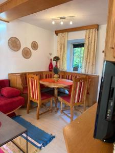 a living room with a table and chairs and a tv at Haus Südsteirische Weinstrasse  +16 photos
