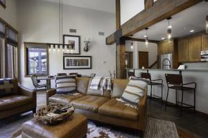a living room with a couch and a kitchen at 3 Bedroom Condo with Spa - Silver Baron Lodge condo in Park City