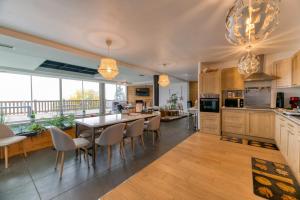 a kitchen with a table and chairs and a dining room at Vacances de rêves - Olympique in Chamrousse