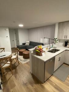 a kitchen and living room with a couch and a table at The SuiteLife, Calgary in Calgary