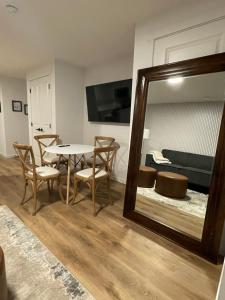 a room with a table and chairs and a mirror at The SuiteLife, Calgary in Calgary