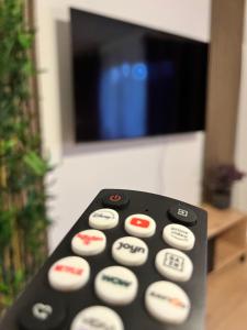a remote control sitting in front of a television at Purple Escape Balkon Netflix zentral in Saarbrücken