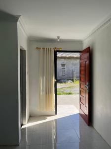 an empty room with a door and a window at JANNAH Syariah in Takengon +10 photos