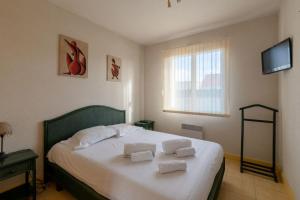 a bedroom with a bed with two pillows on it at La Tara - Vue mer - Parking - Terrasse in La Plaine-sur-Mer