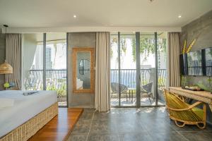 a bedroom with a large bed and a balcony at The Signature Hotel Nha Trang in Nha Trang