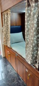 a bed in a wooden cabin in a boat at Sunlight Dormitory in Mumbai