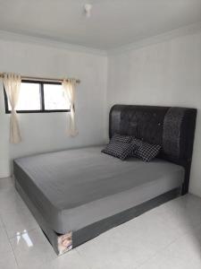 a large bed in a room with a window at JANNAH Syariah in Takengon
