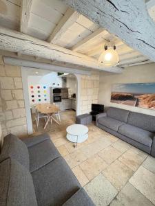 a living room with a couch and a table at Holiday in Arles -Maison du Centre Historique in Arles