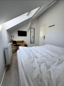 a bedroom with a large white bed and a desk at Vognstrupgaard in Silkeborg