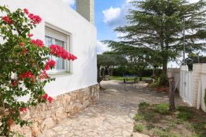 a house with a window with red flowers on it at Mas Vilet by Unik Vacation in Catllar +73 photos