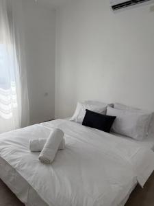 a white bed with white sheets and pillows at צליל ההר - The sounds of the mountain in Safed