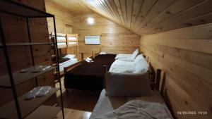 a room with two beds in a wooden cabin at Gaul Gavkhe Hotel in Khalde