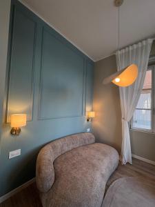 a living room with a circular couch and a window at Pep's Rooms by the sea in Trieste