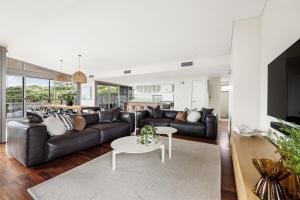 a living room with a couch and a table at Seabreeze Escape, Coastal Stay in Gnarabup