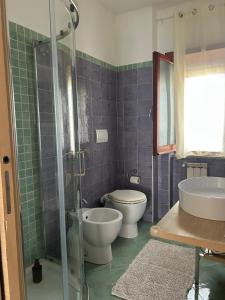 a bathroom with a shower and a toilet and a sink at Civico 82 in Hermada +28 photos