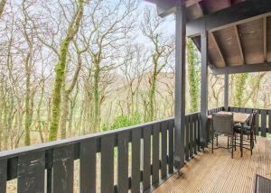 a screened in porch with a table and chairs on it at Brockwood Hall Lodges in Silecroft