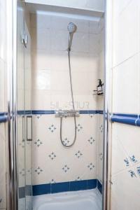 a shower in a bathroom with a tub at Clave Norte By Silastur in Gijón
