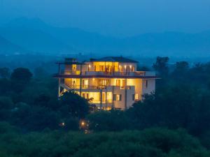 a house sitting on top of a hill at night at Dilip Niwas in Udaipur
