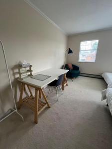 a room with a desk and a bed and a desk at Modern bedroom in Vancouver West in Vancouver