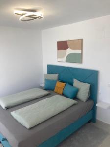 a blue couch with pillows on it in a room at SUNLIGHT Spain in Manilva