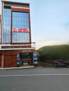 a building with a sign on the side of it at Aakarsh Hill View Hotel in Rājgīr