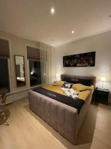 a bedroom with a large bed in a room with windows at Weezen by Gracht in Zwolle