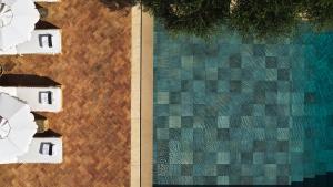 an overhead view of a swimming pool next to a building at The Margi in Athens