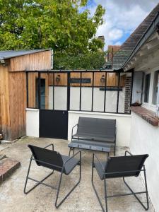 a patio with two chairs and a picnic table at Maison du bonheur in Combres