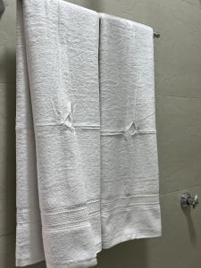 a group of white towels on a towel rack in a bathroom at Cozy Homes in Ruaka