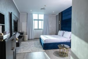 a hotel room with a bed and a window at Palazzo hotel in Kuwait