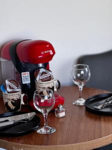 a table with a coffee maker and wine glasses on it at Mini Studio N6 private Bathroom and Kitchenette in Limassol +9 photos