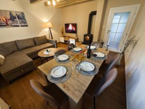 a living room with a table and a couch at Pineta Blidinje in Blidinje