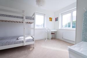 a bedroom with a bunk bed and a desk at 4-bedroom New House Near City Centre in Manchester