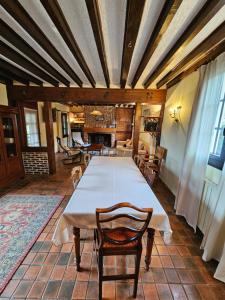 a large dining room with a table and chairs at Maison normande au cœur de Le Bec-Hellouin in Le Bec-Hellouin