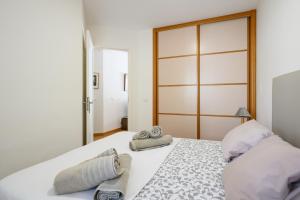 a bedroom with a large white bed with towels on it at Lovely Peaceful Home By CanariasGetaway in San Agustin +25 photos