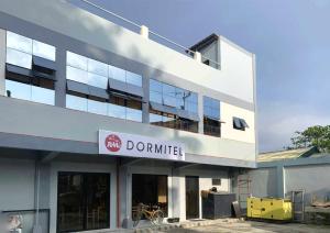 a building with a sign that reads donutmill at RM Dormitel by RedDoorz in Butuan