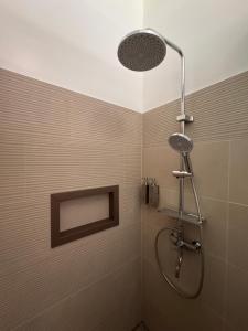 a shower with a shower head in a bathroom at Onda Resort Pacifico in San Isidro +33 photos