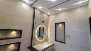 a bathroom with a sink and a mirror at AA Loft in Lahore +13 photos