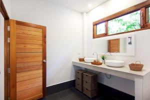 a bathroom with two sinks and a mirror at Authentic 2BR Villa in Koh Phangan in Ko Ma +15 photos