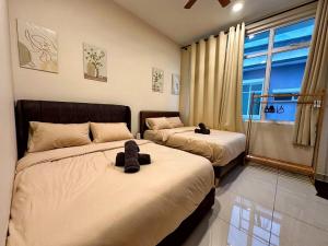 a bedroom with two beds with stuffed animals on them at Desaru 918 Muji Villa in Bandar Penawar +77 photos