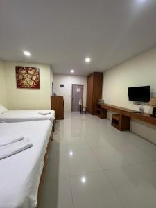 a hospital room with two beds and a flat screen tv at Baan Phu Chalong Place in Ban Suan